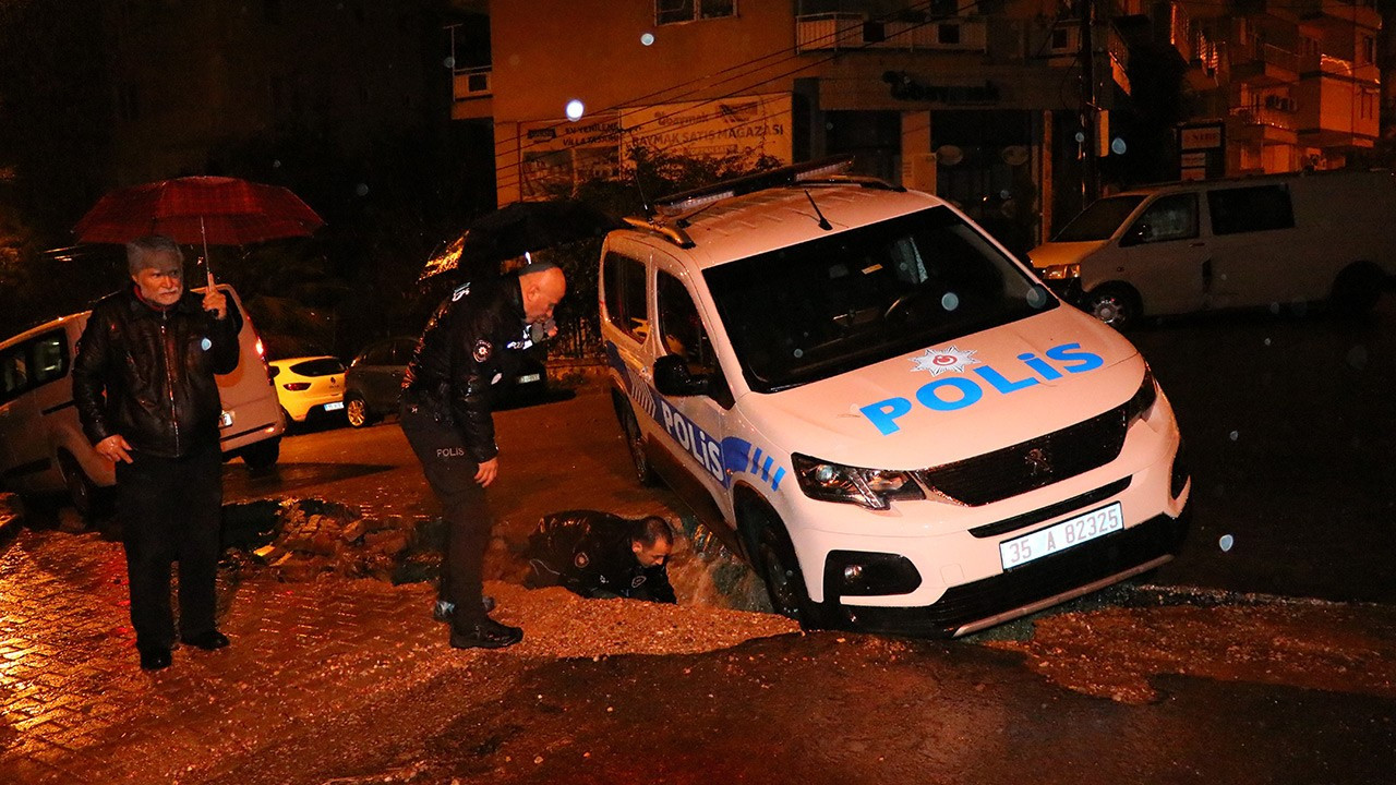 İzmir'de sağanak: Polis aracı çöken yolun içine düştü